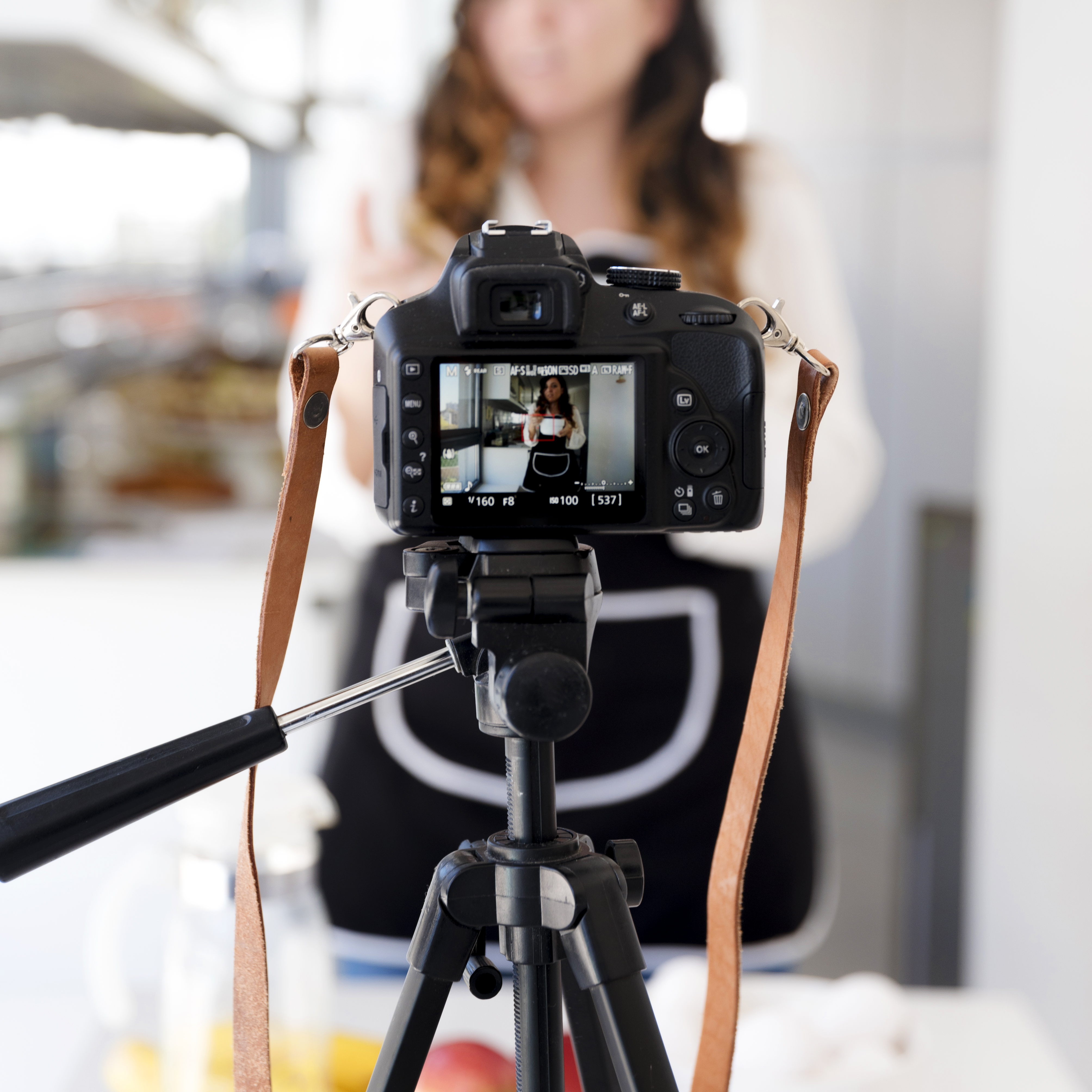 camera-filming-woman-kitchen